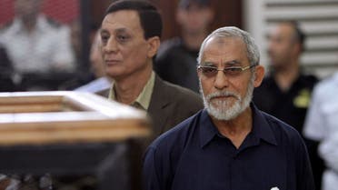 Muslim Brotherhood's Supreme Guide Mohamed Badie (R) looks on during his trial at a court in Cairo, in this May 18, 2014 file picture. reuters