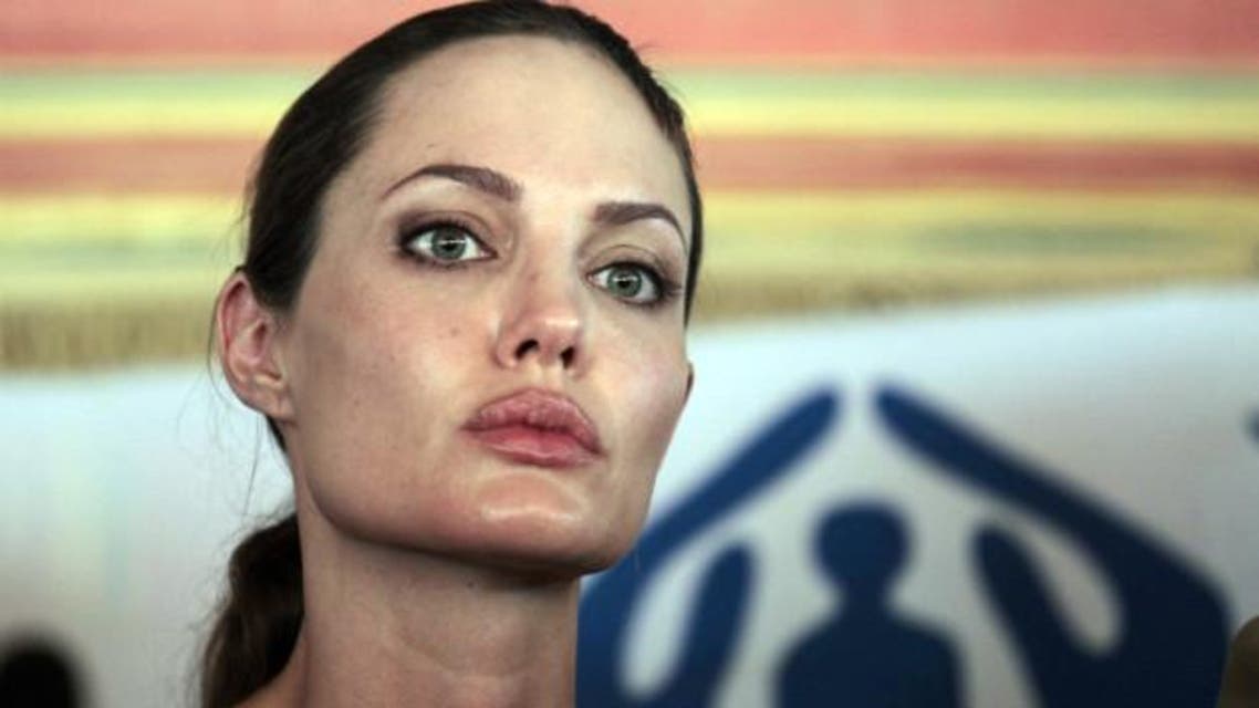 Jolie briefs the press during her visit to the Za'atri camp near Jordan's border with Syria in 2012. (AFP)