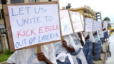 Women of the group "Peace Mothers" hold placards to raise awareness for the Ebola in central Monrovia on September 1, 2014. (AFP)