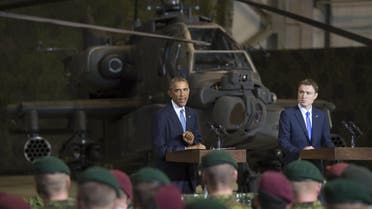 S President Barack Obama (L) speaks next to Prime Minister Taavi Roivas of Estonia to US and Estonian members of the military at a hangar at Tallinn Airport in Tallinn, Estonia, September 3, 2014.