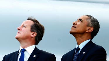 Britain's Prime Minister David Cameron (L) and U.S. President Barack Obama watch a fly-past by the Red Arrows during the NATO summit 