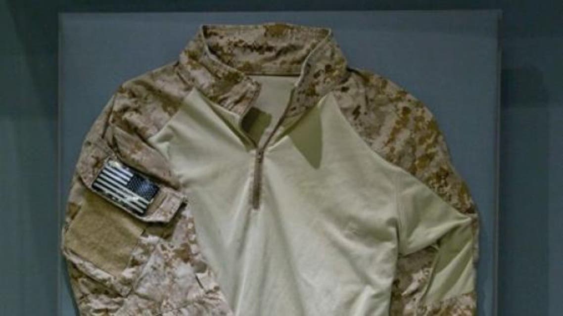 The uniform shirt, tan with camouflage sleeves and an American flag patch belonged to a now-retired member of SEAL Team Six. (Photo courtesy: AP)