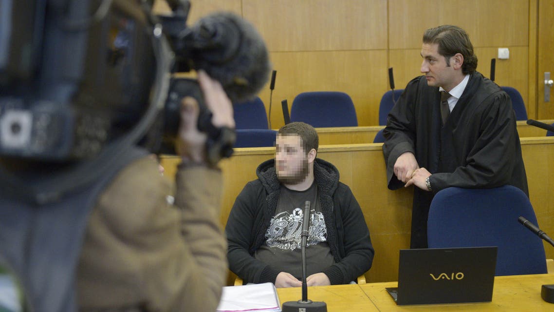 German alleged jihadist Kreshnik B (C) waits next to his lawyer Mutlu Guenal (L) as he arrives at the higher regional court in Frankfurt. (AFP)