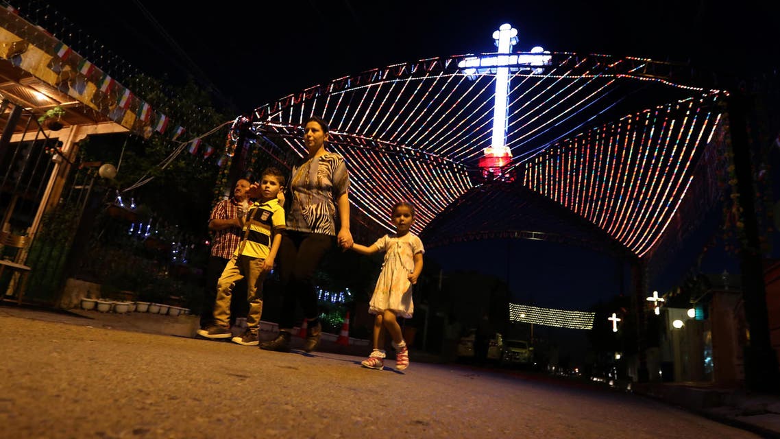 Some Iraqi Christians fled to other cities in Iraq, such as Mosul. Iraqi Christians walk past a decorations displayed in commemoration of the Elevation of the Holy Cross festival in Erbil, the capital of the Kurdish autonomous region in northern Iraq, Sept. 15, 2014. (AFP)