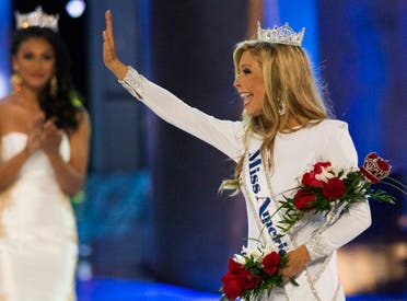 Miss New York Kira Kazantsev (R) waves near Miss America 2014 Nina Davuluri after she was crowned as the winner of the 2015 Miss America Competition in Atlantic City, New Jersey September 14, 2014. (Reuters)