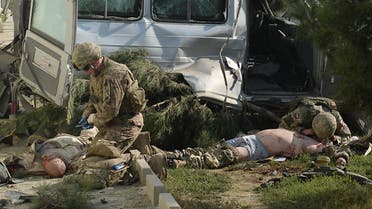 Foreign troops give first aid to foreign victims at the site of a suicide attack in Kabul on September 16, 2014. (AFP)