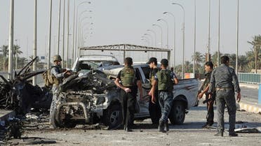 Iraqi security forces inspect the site of a suicide bombing on a bridge in Ramadi, west of Baghdad, September 17, 2014. (Reuters)