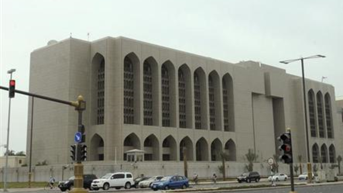Vehicles stop at a red light in front of the main branch of UAE Central Bank in Abu Dhabi, January 29, 2013