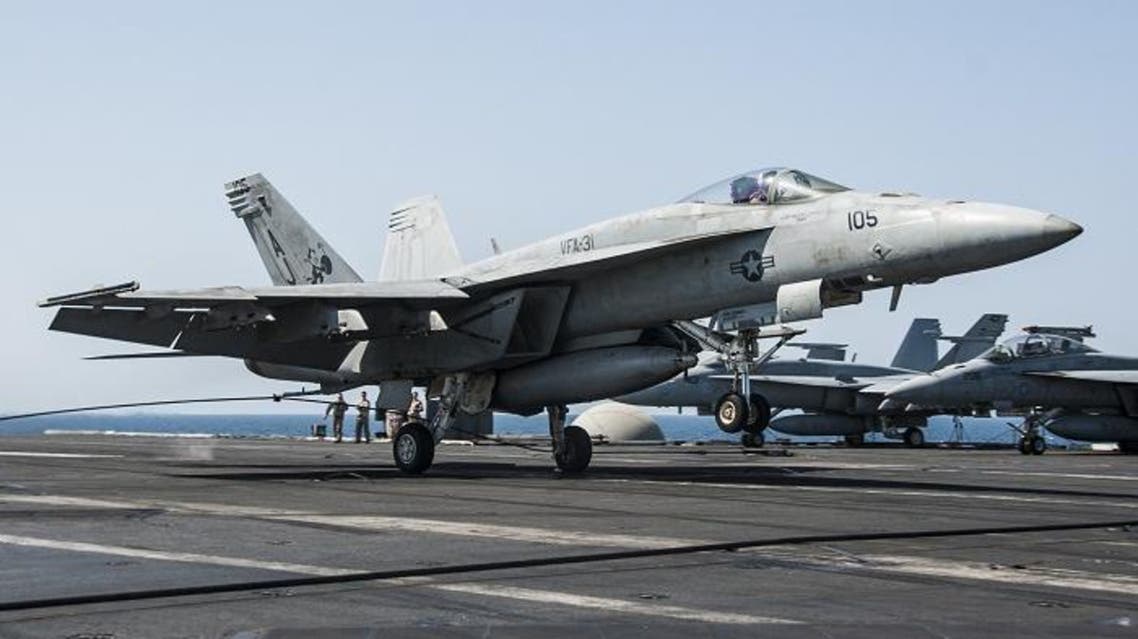 In this picture downloaded from the US Navy website and taken on September 23, 2013, an F/A-18E Super Hornet attached to the Tomcatters of Strike Fighter Squadron (VFA) 31 lands aboard the aircraft carrier USS George H.W. Bush (CVN 77)after conducting strike missions against Islamic State (IS) group targets. (AFP)