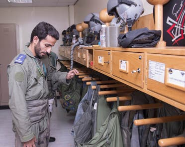  In a handout picture released by the official Saudi Press Agency (SPA), a Saudi Arabian air force pilot looks at flying jackets at an undisclosed location on September 23, 2014. AFP 