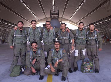  In a handout picture released by the official Saudi Press Agency (SPA), Saudi Arabian air force pilots pose for a photo at an undisclosed location after taking part in a mission to strike Islamic State (IS) group targets in Syria on September 23, 2014. AFP 