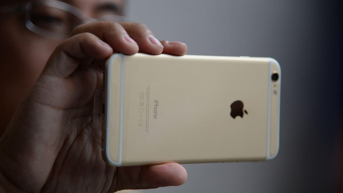 A man as he checks out his iPhone 6 Plus outside the Apple store in Pasadena, California. (AFP)