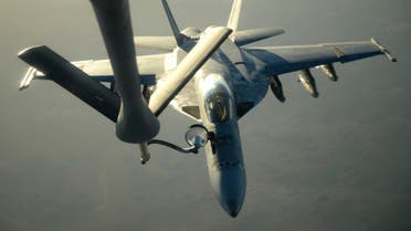 A U.S. Navy F-18E Super Hornet receives fuel from a KC-135 Stratotanker over northern Iraq after conducting air strikes in Syria on September 23, 2014.  R