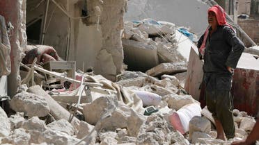 A man stands amidst debris as he inspects collapsed buildings at a site hit by what activists said were barrel bombs dropped by forces of Syria's President Bashar al-Assad, in Aleppo's al-Sakhour district, September 27, 2014.  (Reuters)