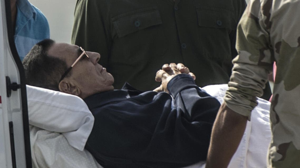  Former Egyptian president Hosni Mubarak is wheeled out of an ambulance outside the Maadi military hospital in Cairo on September 27, 2014. (AFP)