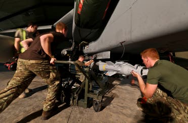 Ground crew load a Paveway IV Laser Guided bomb onto an RAF Tornado GR4's at RAF Akrotiri, Cyprus, in this handout photo from the Ministry of Defence September 26, 2014. (Reuters)