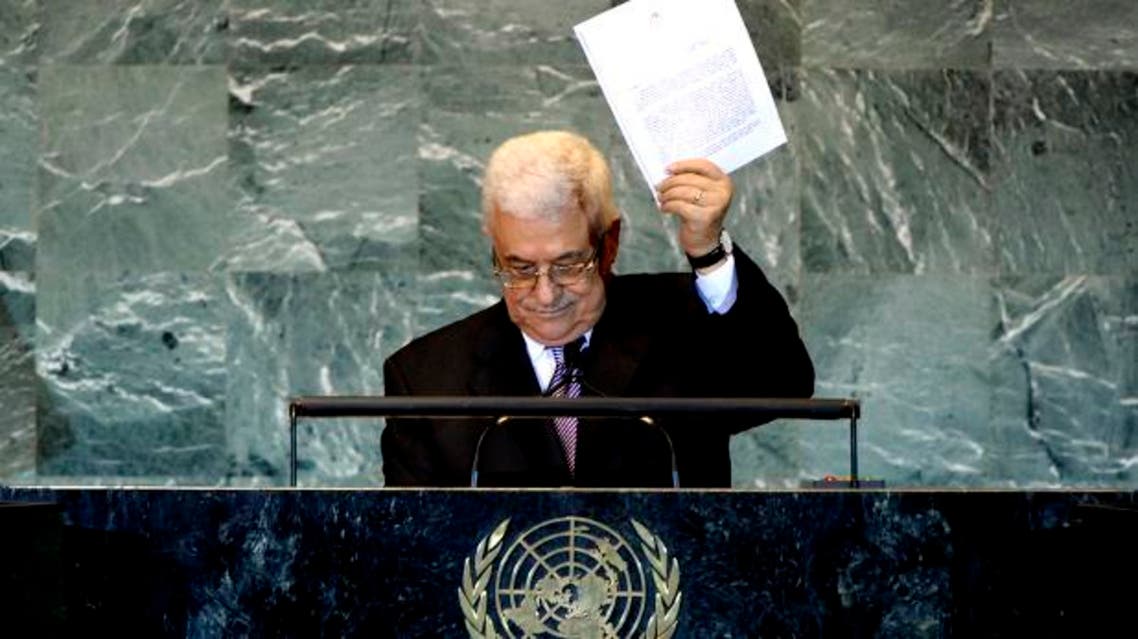 Palestinian President Mahmoud Abbas holds up a copy of the letter that he had just delivered to United Nations Secretary General Ban Ki-moon requesting full United Nations representation for a Palestinian state, during his address before the 66th United Nations General Assembly at U.N. headquarters in New York, September 23, 2011.