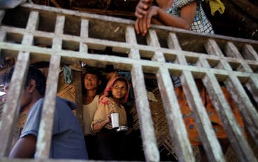 Muslims pass the time at their house in Paik Thay, the site of violence between Muslim Rohingyas and Arakanese Buddhists. (File Photo: Reuters)