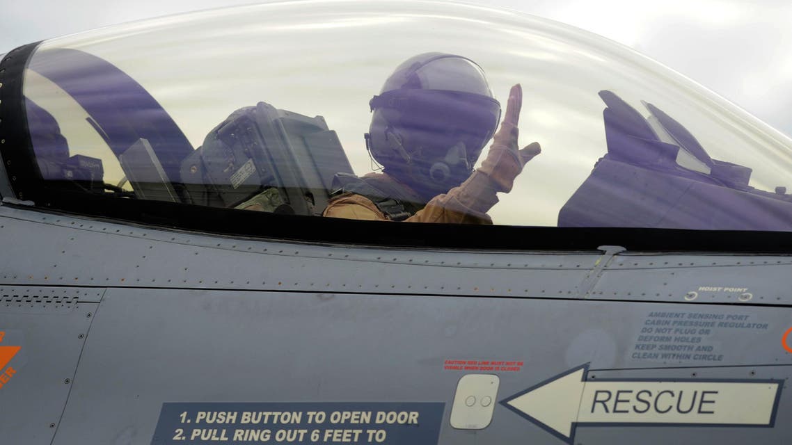 A Belgian F-16 fighter jet pilot gestures while taking off to join an international coalition fighting against ISIS