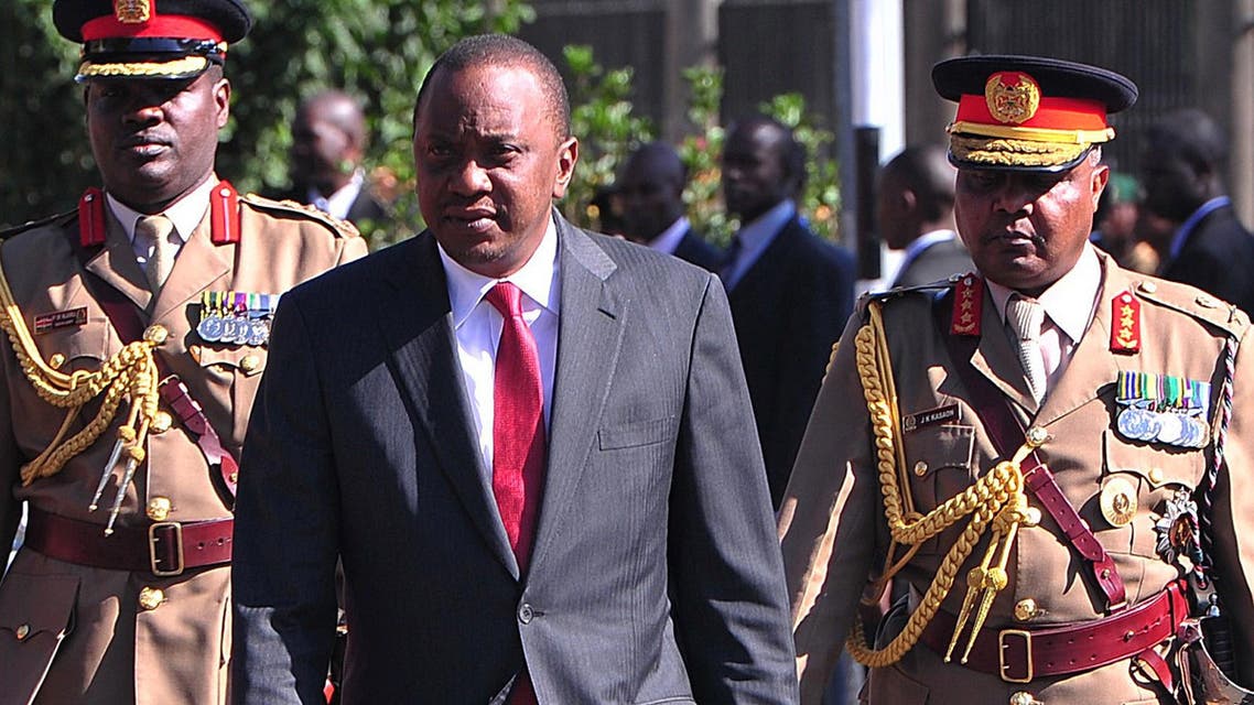 Kenyan President Uhuru Kenyatta (C) reviews an honour guard before addressing a special legislative session in parliament in Nairobi on Oct. 6, 2014. (AFP)