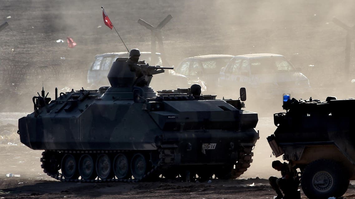 Turkish soldiers patrol along the Turkish border with Syria, in the southeastern town of Suruc, in Sanliurfa province, on October 8, 2014.