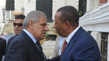 Egypt PM Ibrahim Mahlab (L) greets his Libyan counterpart Abdullah al-Thani in Cairo on October 8, 2014. (AFP)