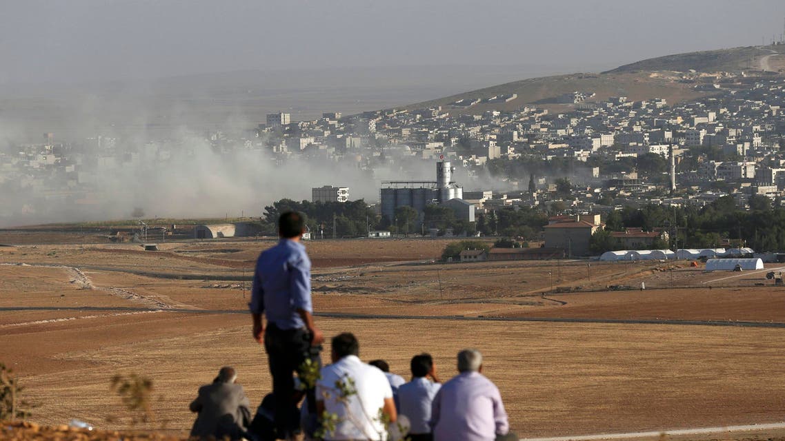 Turkish Kurds look towards the Syrian Kurdish town of Kobani from the top of a hill close to the border line between Turkey and Syria near Mursitpinar bordergate October 10, 2014. (Reuters) Kobane