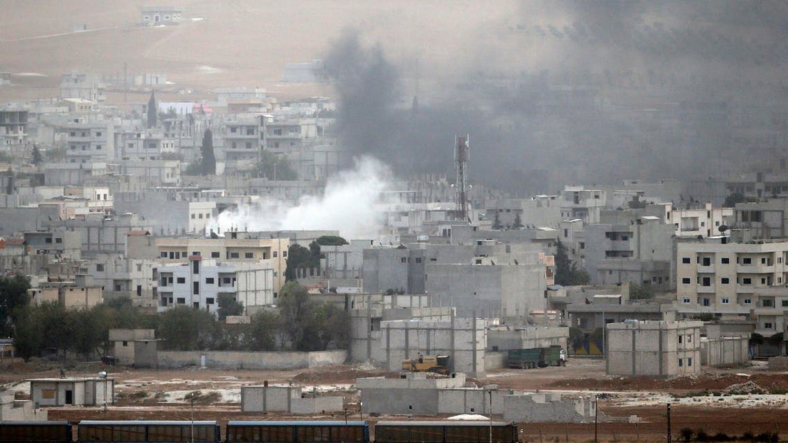 Smoke rises from the Syrian town of Kobani, as seen from the southeastern town of Suruc in Sanliurfa province October 11, 2014. (Reuters)