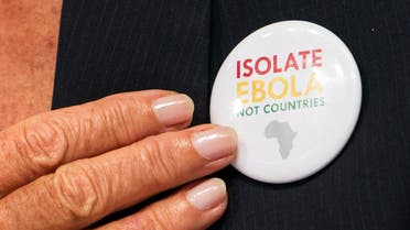 International Monetary Fund (IMF) Managing Director Christine Lagarde points to a button saying "Isolate Ebola, Not Countries" as she speaks during the IMFC news conference during the World Bank/IMF Annual Meeting in Washington October 11, 2014. (Reuters)
