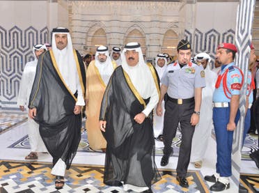 Qatari Emir Sheikh Tamim bin Hamad al-Thani, left, arrives at King Abdulaziz International Airport. (Saudi Press Agency) 