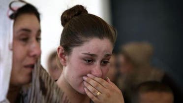 A Yazidi woman cries in the Kurdish city of Dohuk. (AFP)