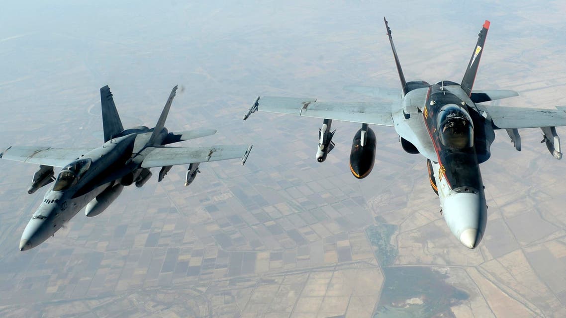 U.S. Navy F-18E Super Hornet jets leave to support military operations against ISIL
