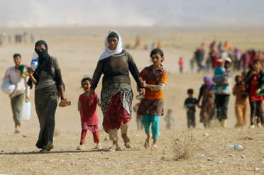 Displaced people from the minority Yazidi sect, fleeing violence from forces loyal to ISIS in Sinjar town, walk towards the Syrian border, on the outskirts of Sinjar mountain, near the Syrian border. (File photo: Reuters)