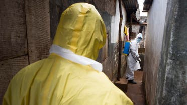 Health workers in protective equipment work near Rokupa Hospital, Freetown October 6, 2014. (Reuters)