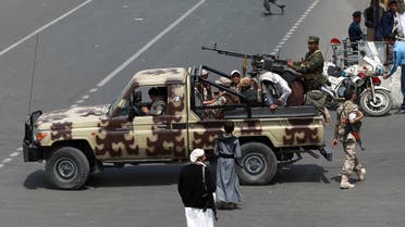 Supporters of the Yemeni Shiite Houthi movement guard a funeral procession, for members of the movement killed in a suicide bombing last week. (AFP)