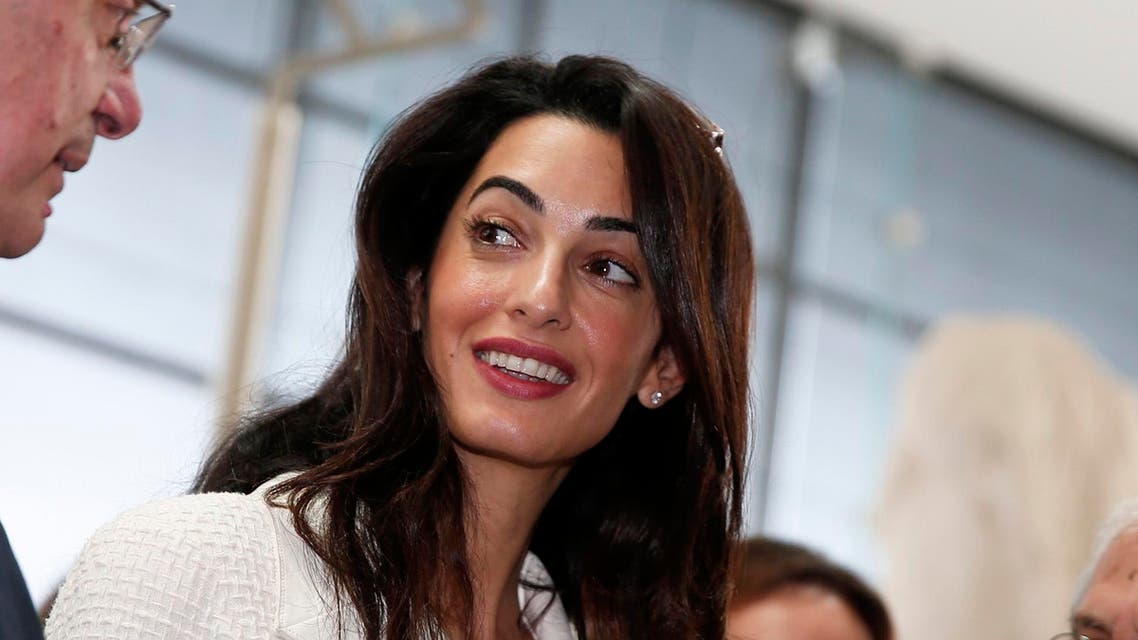 Human rights lawyer Amal Alamuddin Clooney (C) listens to Greece's Culture Minister Konstantinos Tasoulas during a visit at the Parthenon hall inside the museum in Athens October 15, 2014. (Reuters)