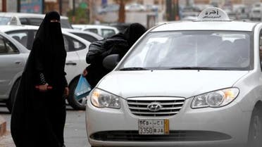 A Saudi woman stands next to a taxi in Riyadh. (Photo courtesy: AP)