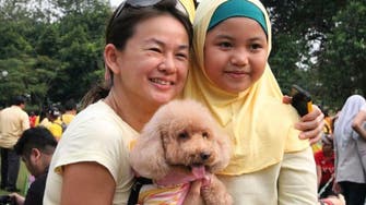 ‘Dog patting’ event upsets Malaysian clerics