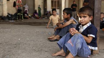 Many Iraq schools open a month late amid crowding by displaced
