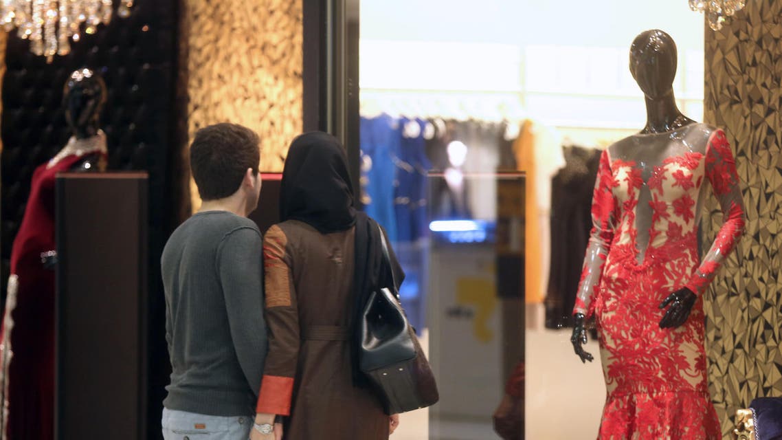 An Iranian couple look at a window display of a shop selling women's clothes at the Laleh Park shopping center in Tabriz in Iran's northwestern East-Azerbaijan province on Oct. 15, 2014. (AFP)