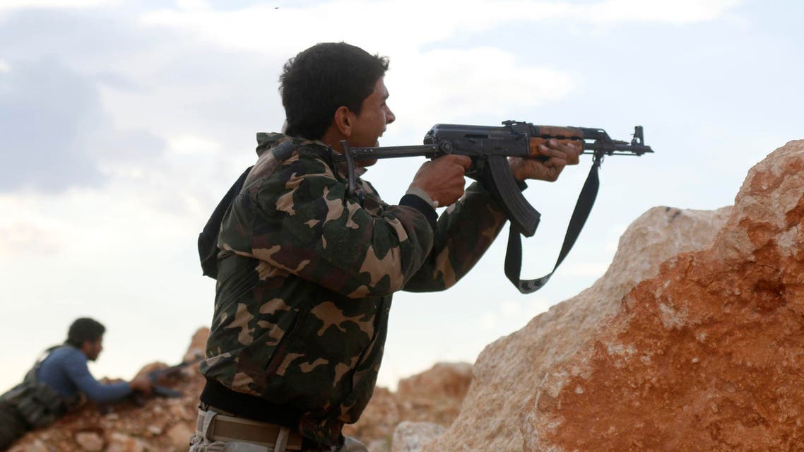 Free Syrian Army fighters shoot their weapons during clashes with forces loyal to Syria's President Bashar al-Assad around Handarat area Oct. 16, 2014. (AFP)