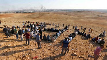 Turkish Kurds gather on the hill near the Mursitpinar border crossing on the Turkish-Syrian border near the southeastern town of Suruc in Sanliurfa province to support Kurdish fighters in Kobane October 15, 2014. (Reuters)