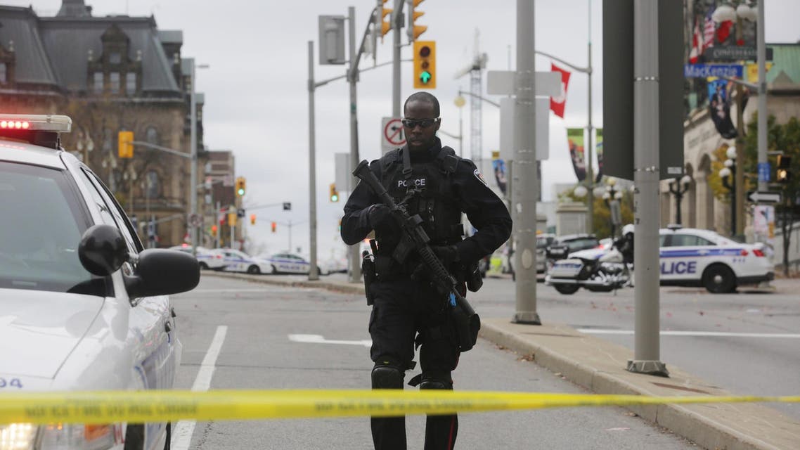 n Ottawa police officer stands guard on Wellington St. after a shooting occurred at the National War Memorial near the Canadian Parliament October 22, 2014 in Ottawa, Canada.