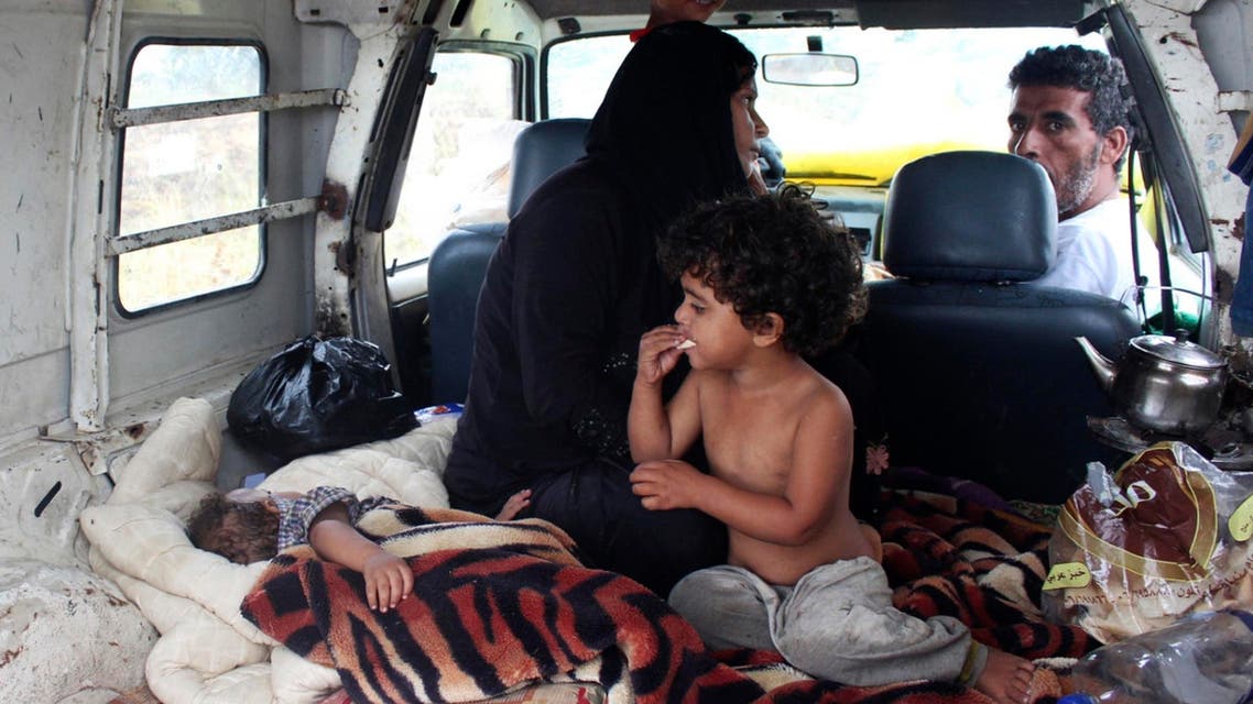 yrian refugees take shelter inside a van after their makeshift tent was damaged by heavy rain in Halba, northern Lebanon, Sept. 28, 2014. (AFP)