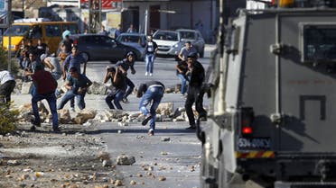  Palestinian youths from the Jalazoun refugee camp clash with Israeli security forces on a road at the entrance of the Jewish West Bank settlement of Beit El, north of Ramallah. (AFP)