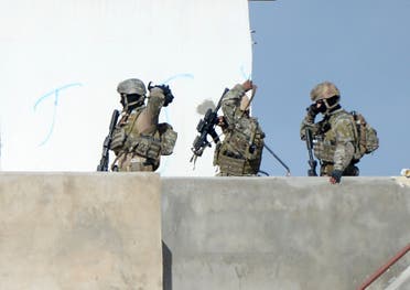 embers of the Tunisian military walk on a balcony during an operation against gunmen in the town of Oued Ellil near the Tunisian capital Tunis on Oct. 24, 2014. (AFP)