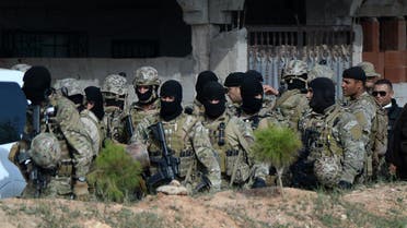 Members of the Tunisian military stand in a group during an operation against gunmen in the town of Oued Ellil near the Tunisian capital Tunis on Oct. 24, 2014. (AFP)