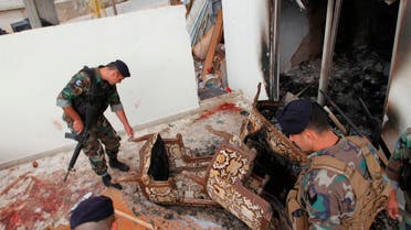 Lebanese army soldiers inspect the damage as bloodstains are seen on the floor following a raid on an apartment, in the northern town of Asoun October 23, 2014. (Reuters)