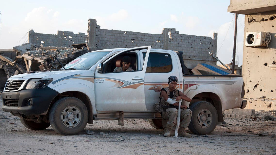 Members of forces loyal to former general Khalifa Haftar sit in and near a truck in the Benina area, east of Benghazi October 24, 2014. (Reuters)