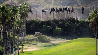 Viral photo shows African migrants gazing at white-clad golfers